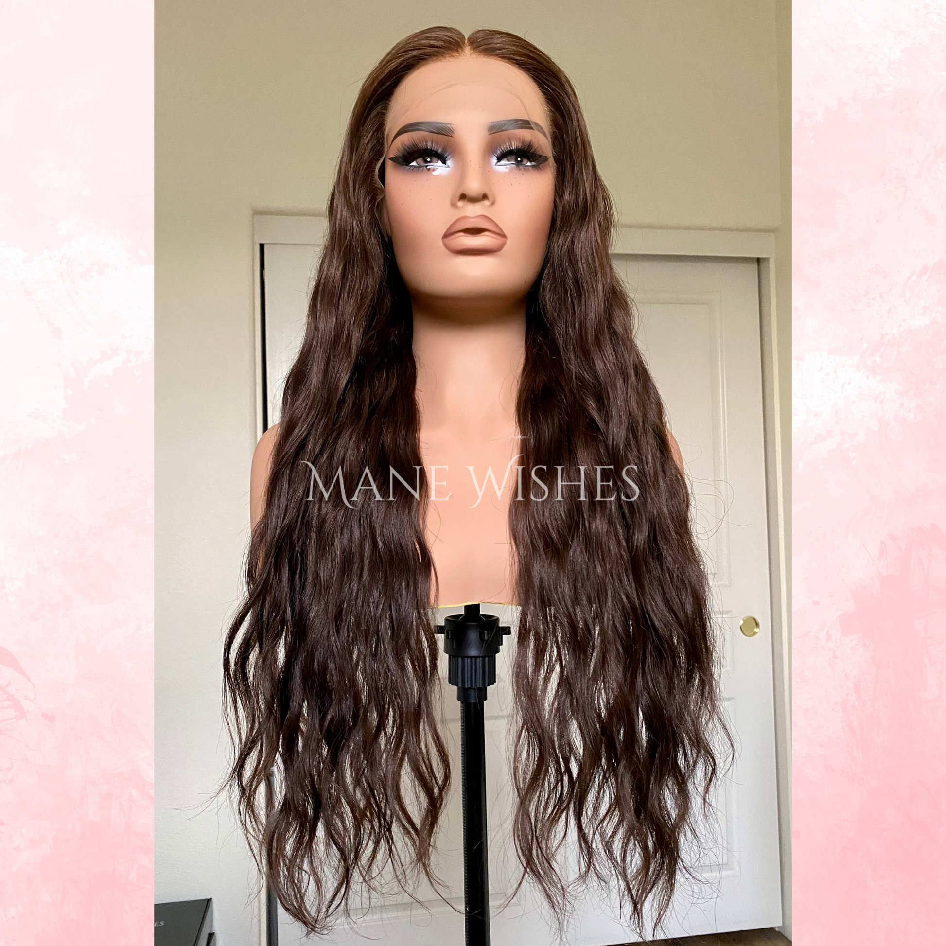 Mannequin head with long brown wig on a stand, branded 'Mane Wishes'.