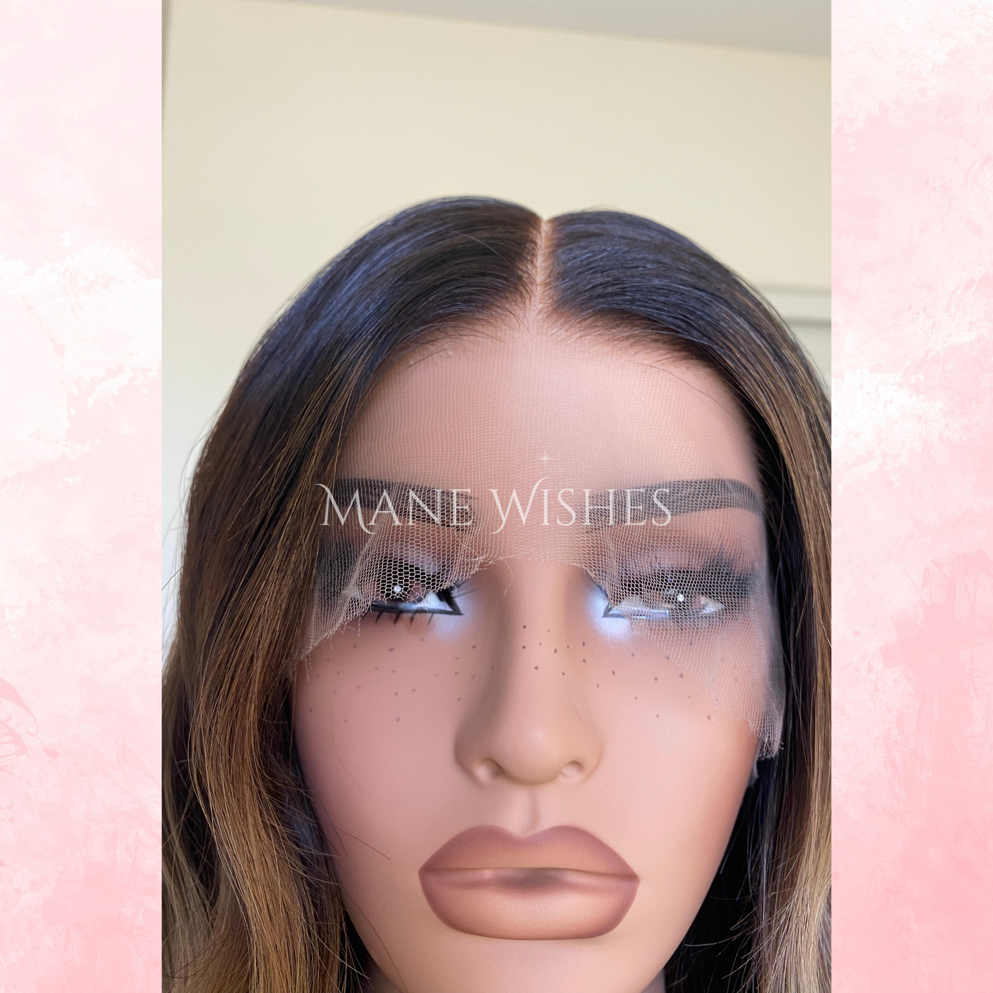 Mannequin head with a wig and 'Mane Wishes' branding on a pink and white background
