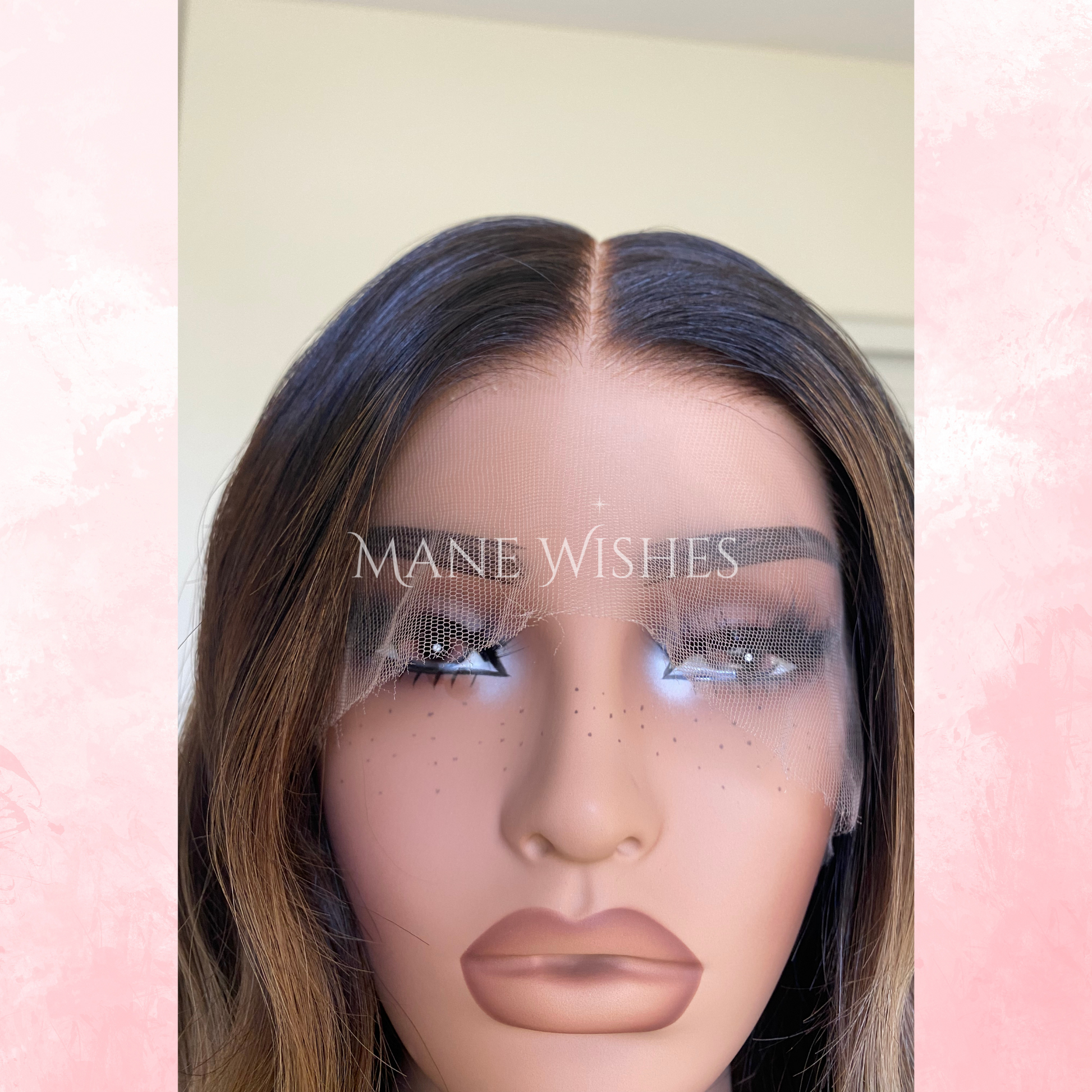 Mannequin head with a wig and 'Mane Wishes' branding on a pink and white background