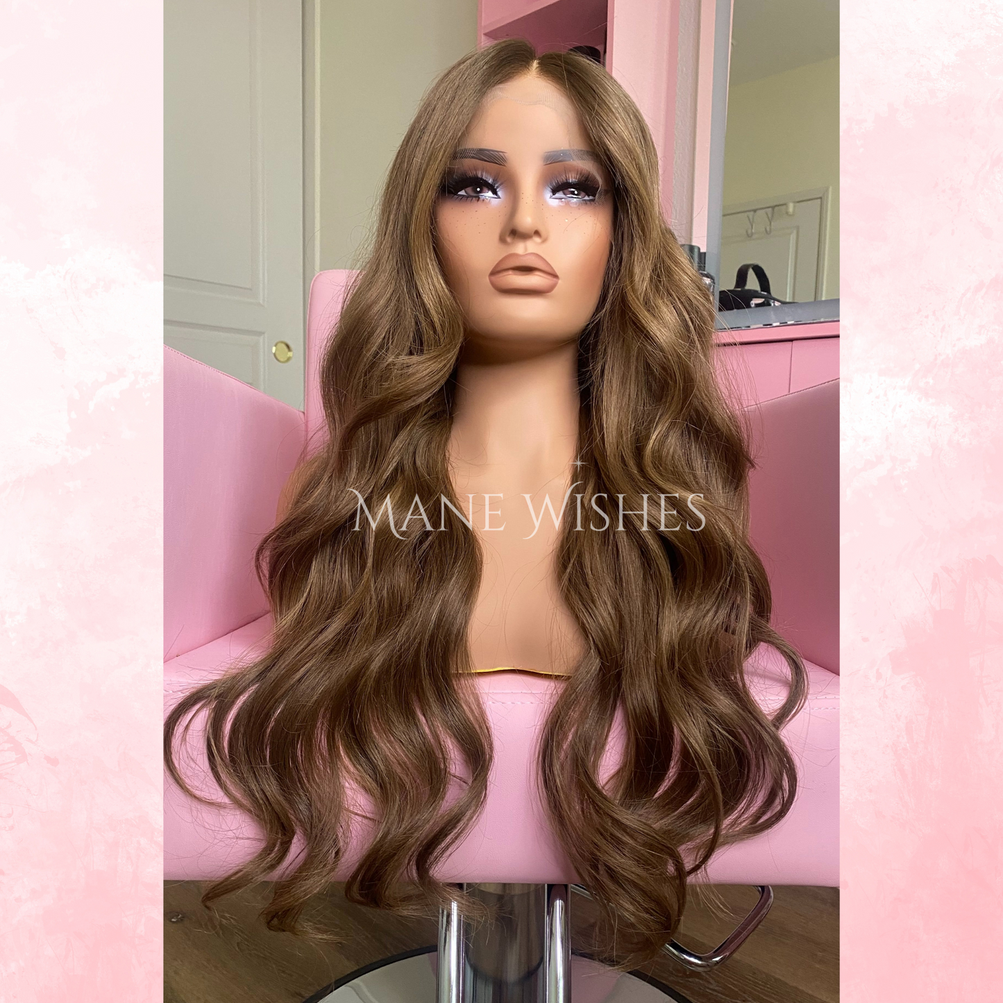 Mannequin head with long brown wig on a pink chair, branded 'Mane Wishes'.