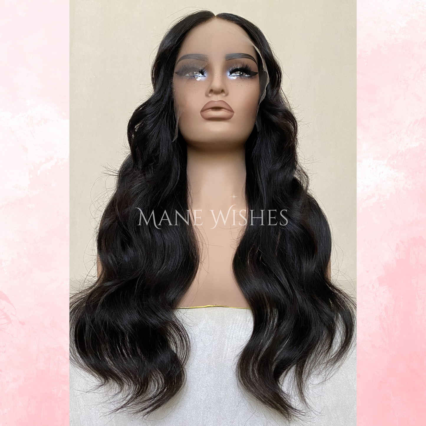 Mannequin head with long black wavy wig on a light pink and beige background, branded 'Mane Wishes'.