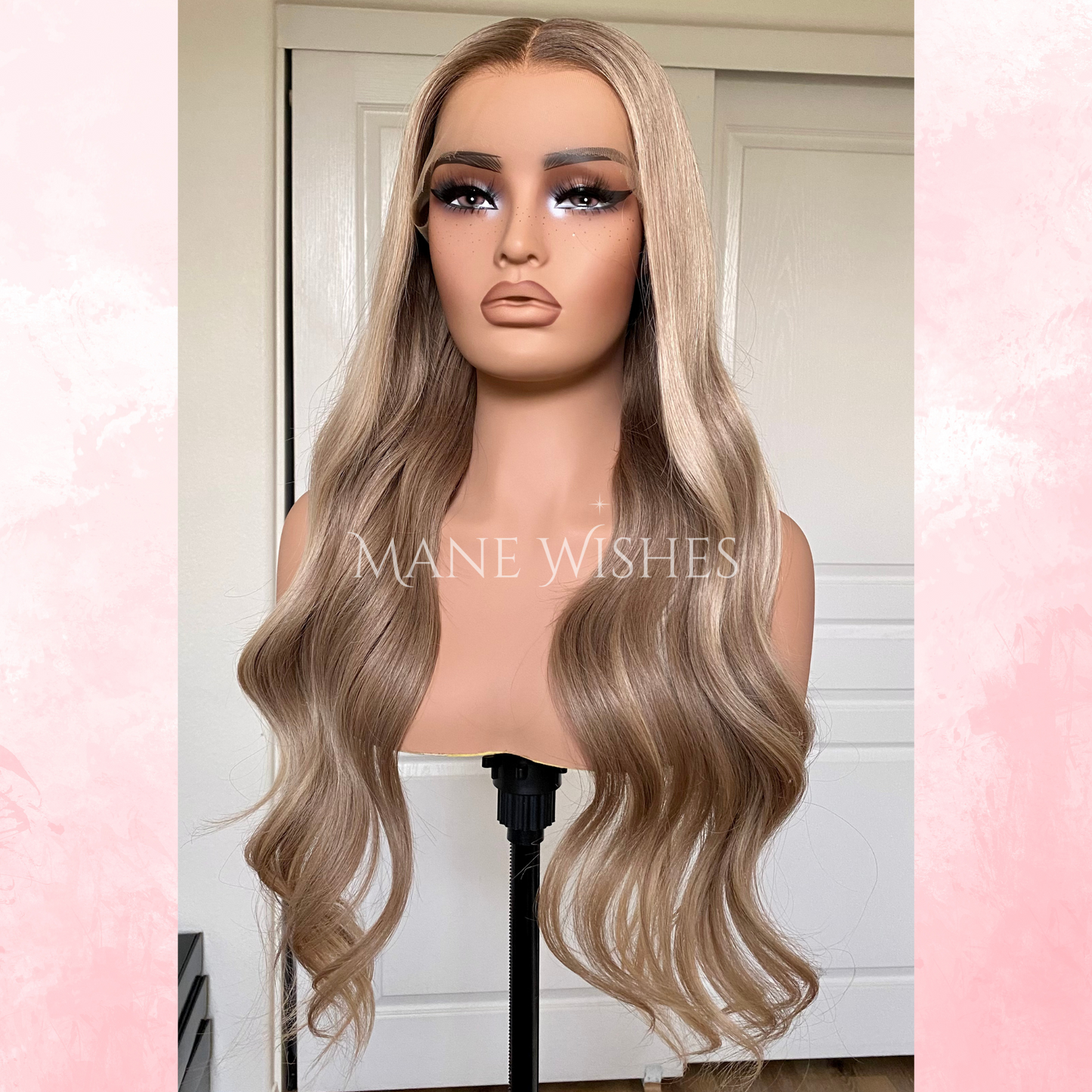 Mannequin head with long, wavy blonde wig on a pink and white background, branded 'Mane Wishes'.