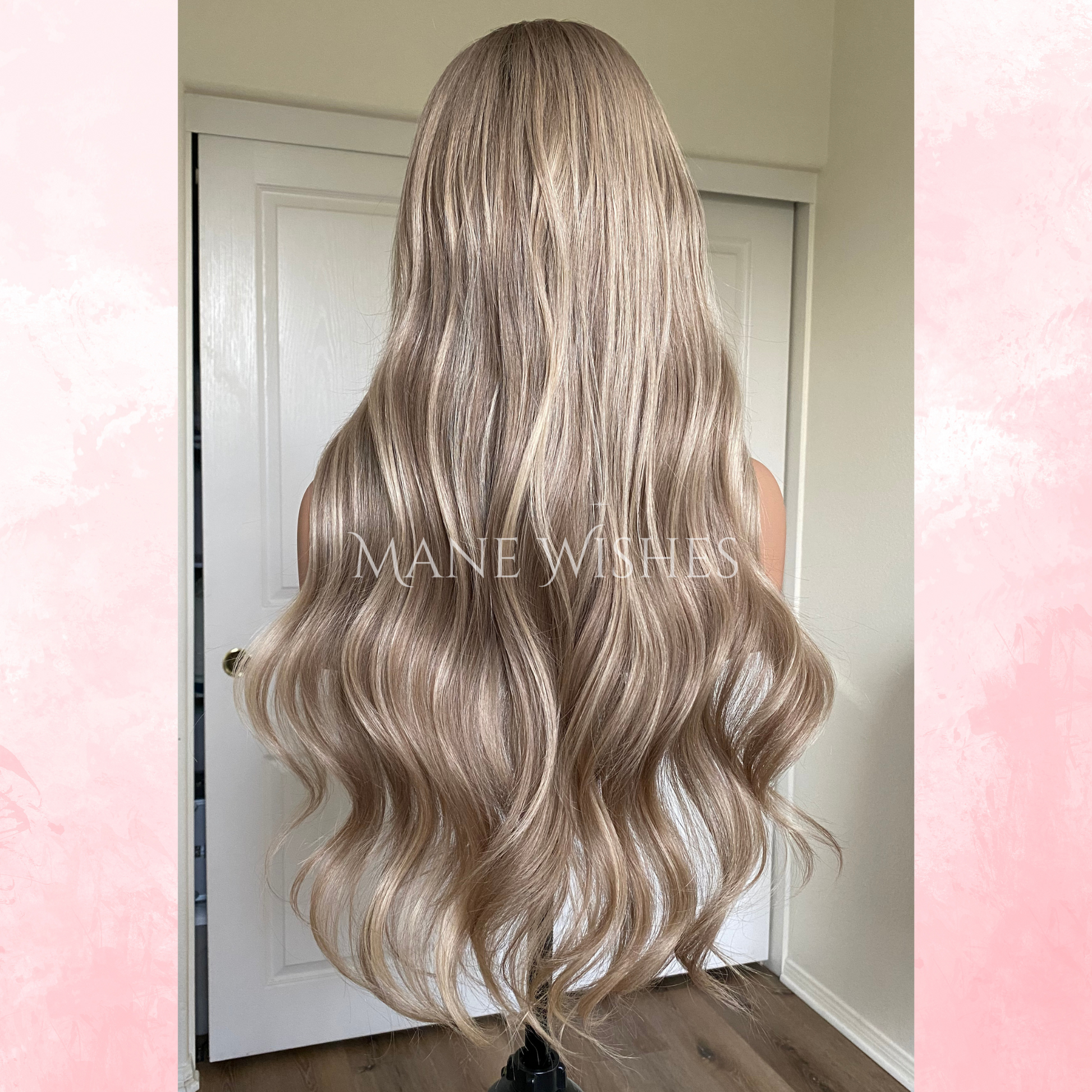 Blonde wig with wavy hair styled in front of a mirror, branded 'Mane Wishes'.