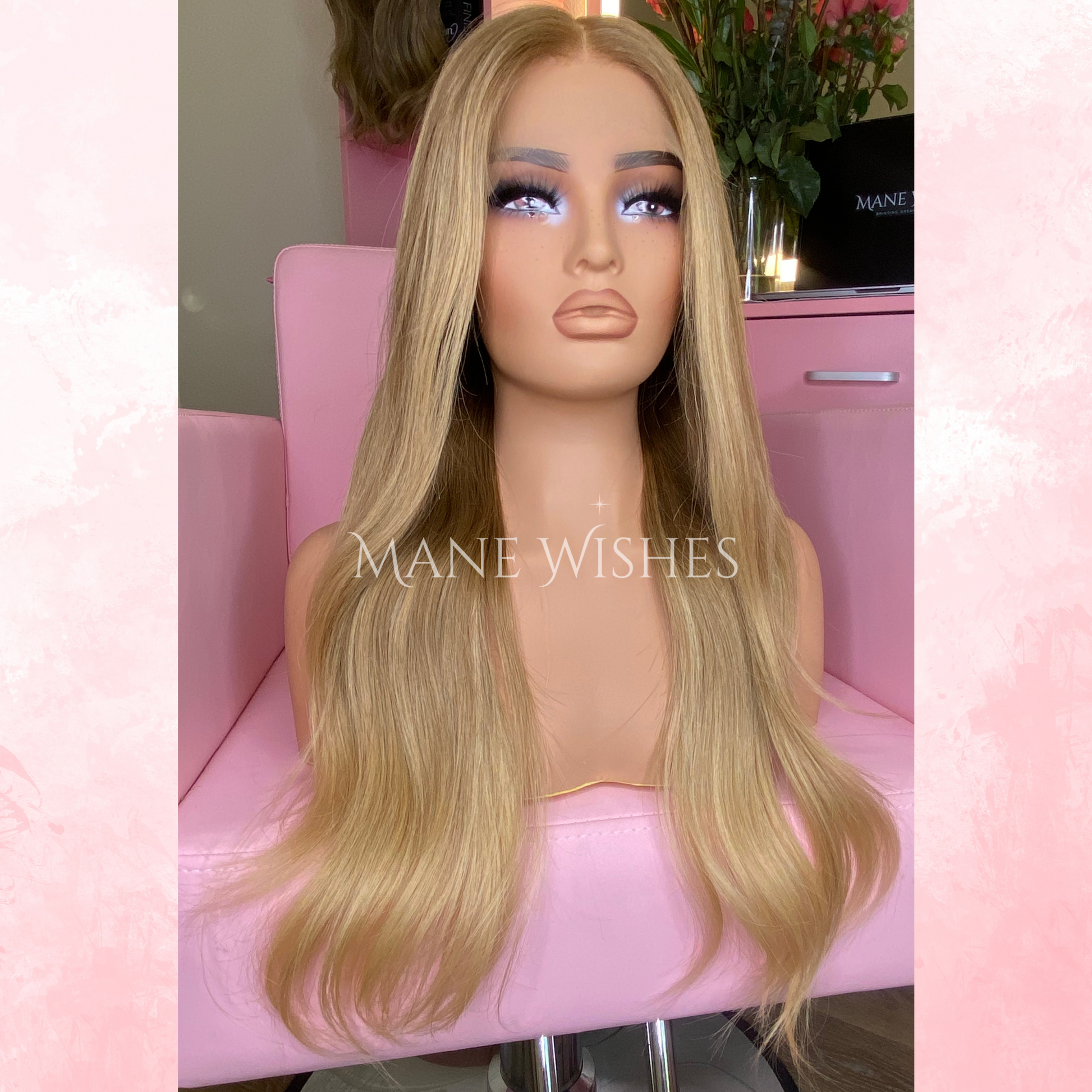 Blonde wig on a mannequin head with 'Mane Wishes' branding, set against a pink background.