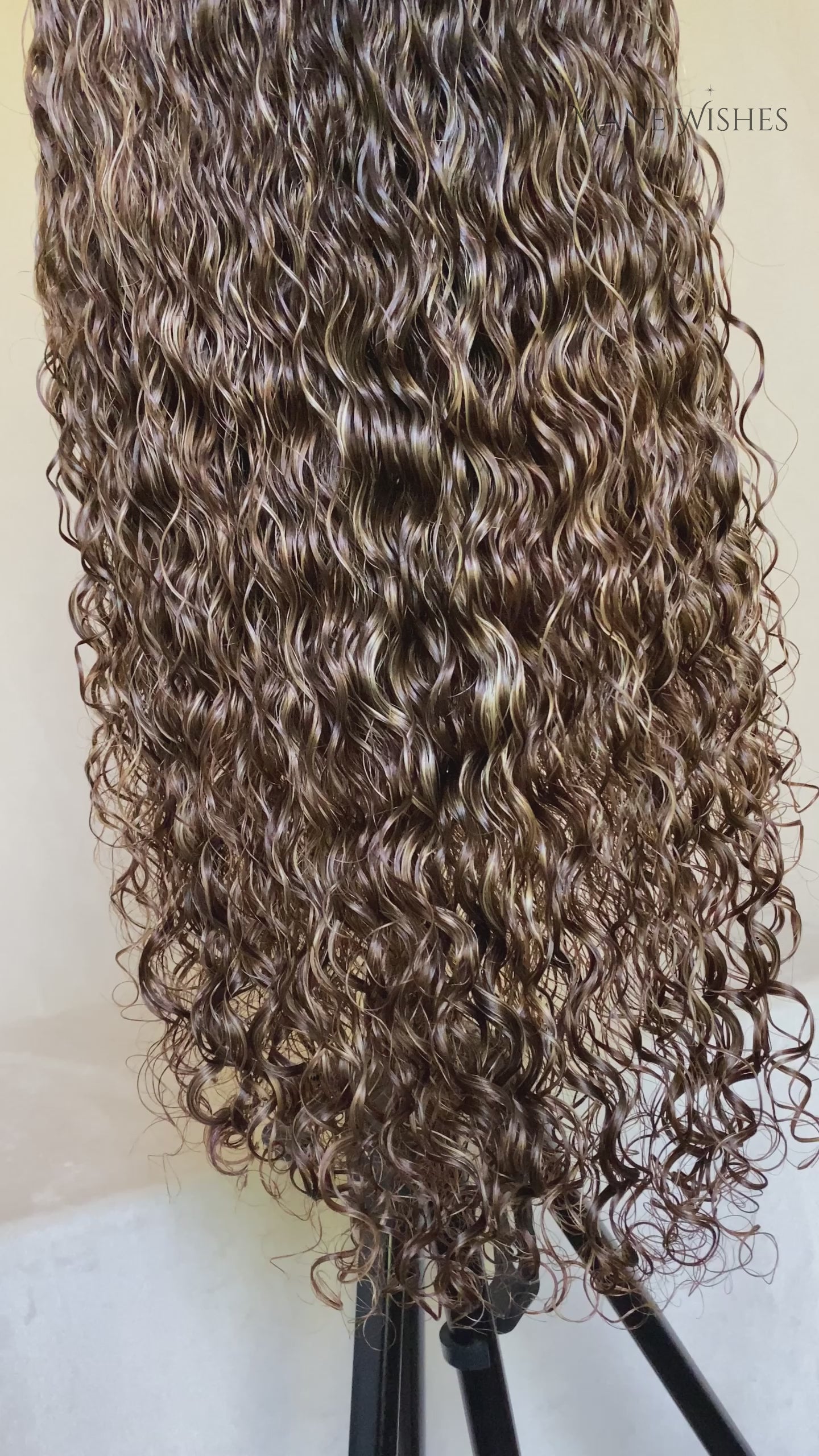 Mannequin head with wavy brown hair and 'Mane Wishes' branding.