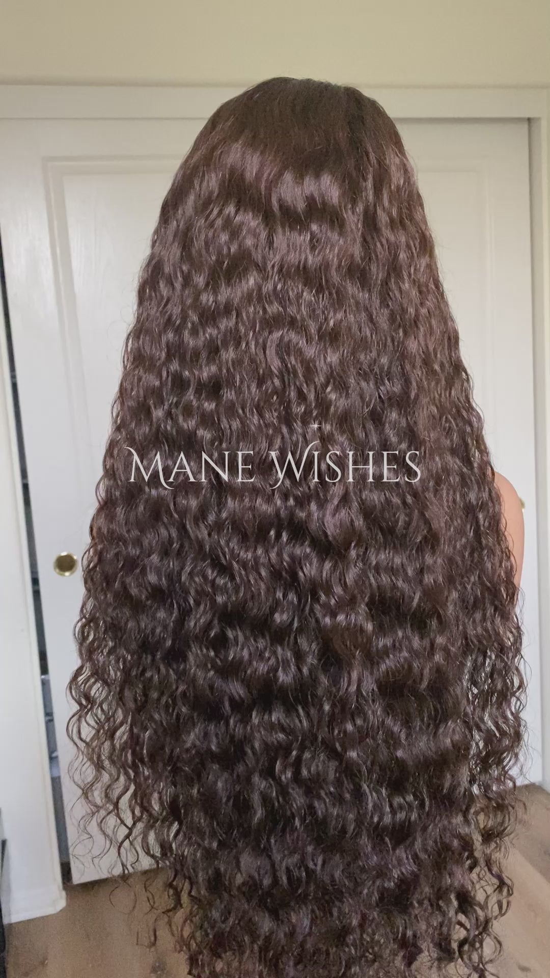 Curly hair extension with 'Mane Wishes' branding against a neutral background