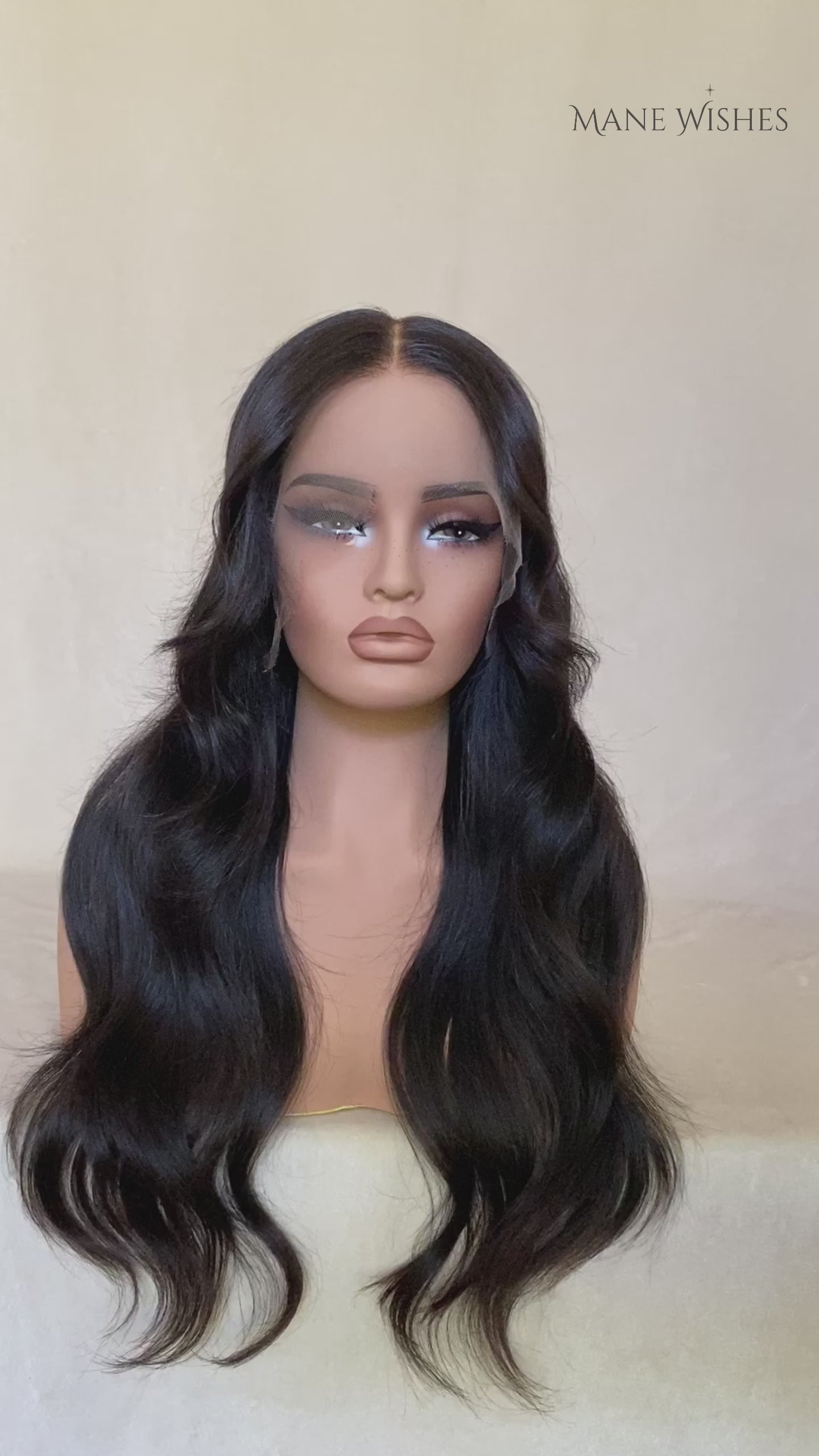 Mannequin head with long black wavy hair on a white background, branded 'Mane Wishes'.