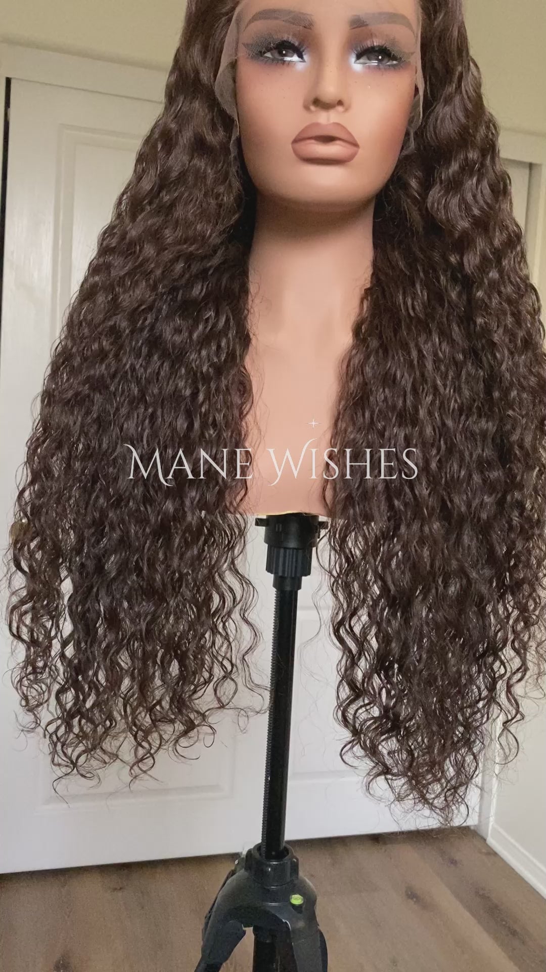 Curly hair extension with 'Mane Wishes' branding against a neutral background