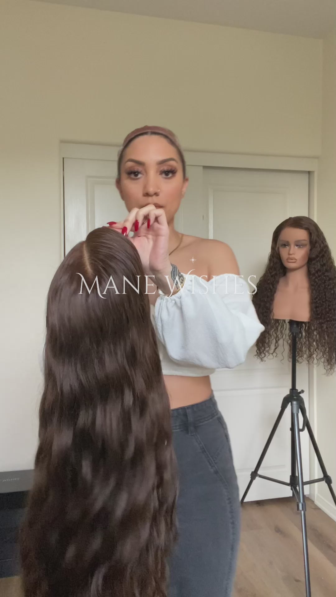 Mannequin head with long brown wig on a stand, branded 'Mane Wishes'.