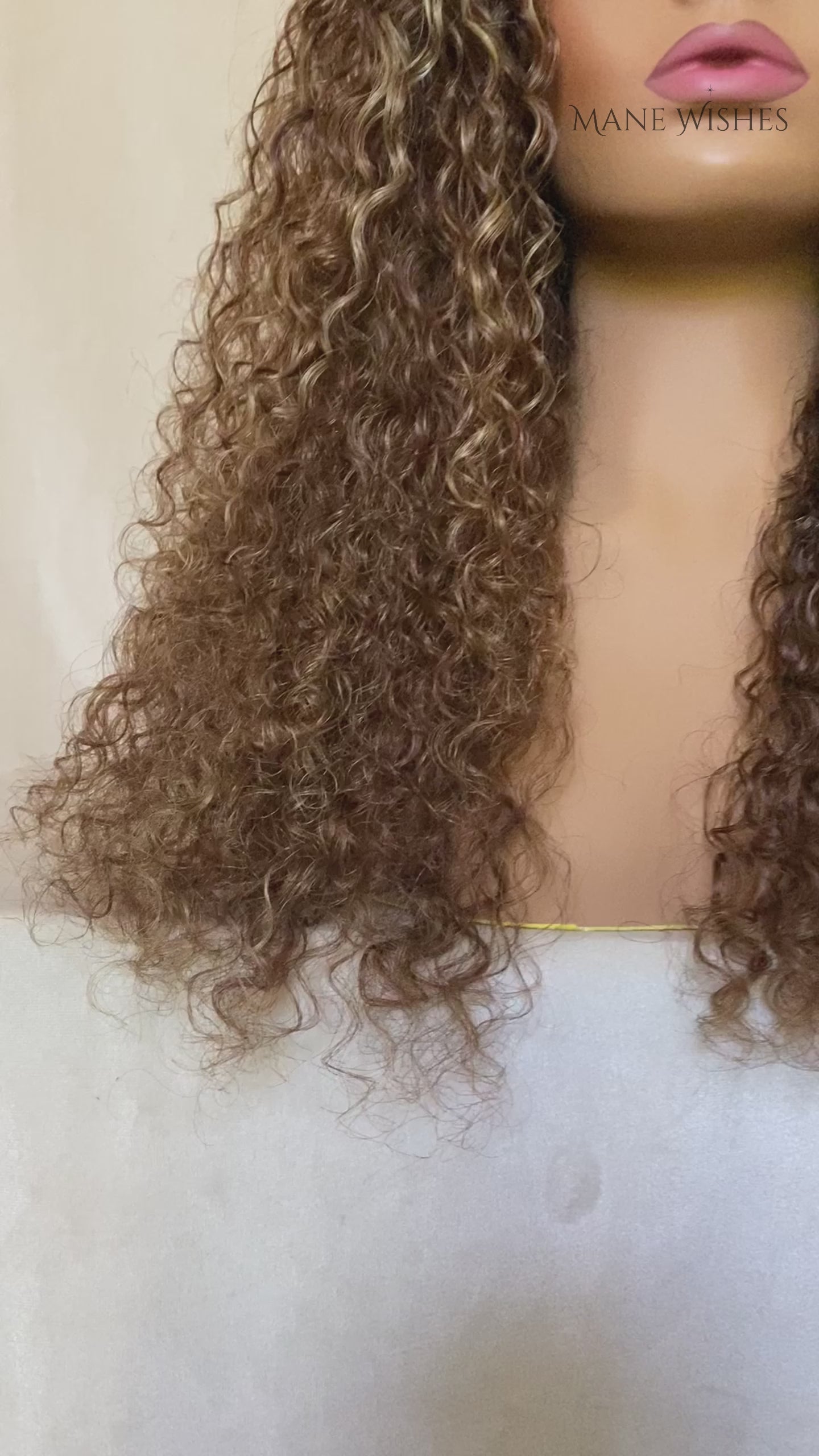 Mannequin head with wavy brown hair and 'Mane Wishes' branding.