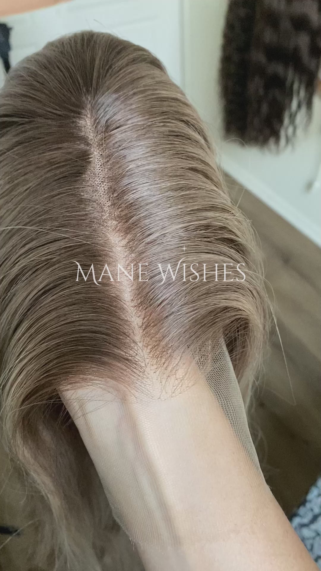 Blonde wig on a mannequin head with 'Mane Wishes' branding against a white door background.