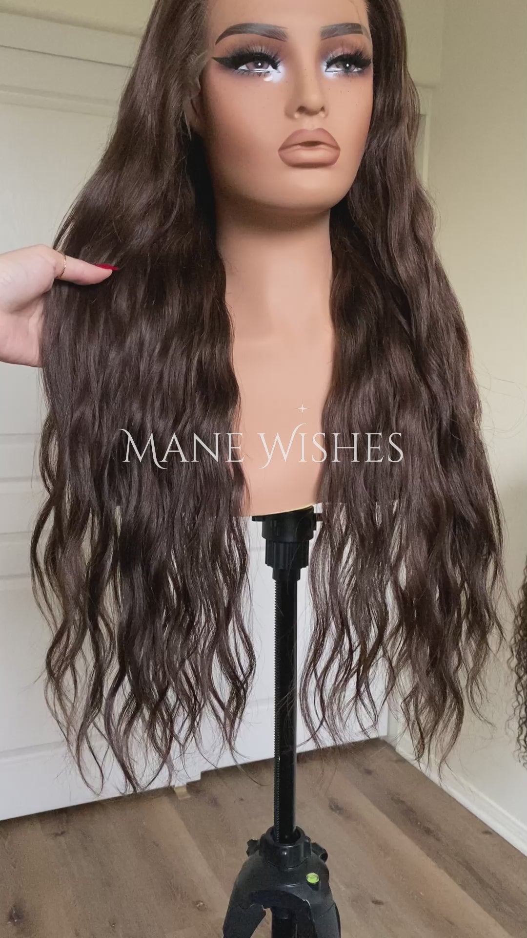 Mannequin head with long brown wig on a stand, branded 'Mane Wishes'.