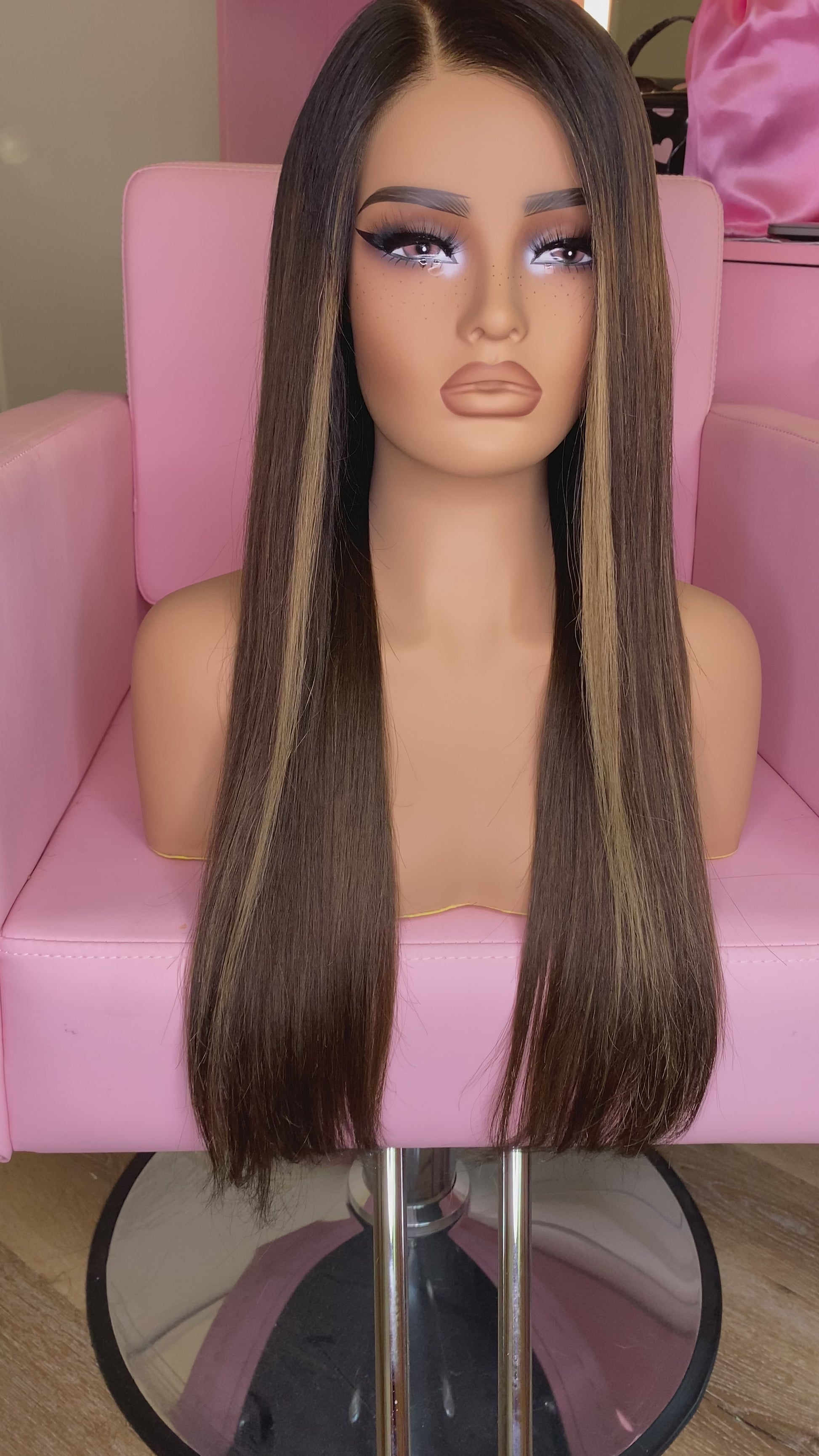 Mannequin head with long brown wig on a pink chair, branded 'Mane Wishes'.