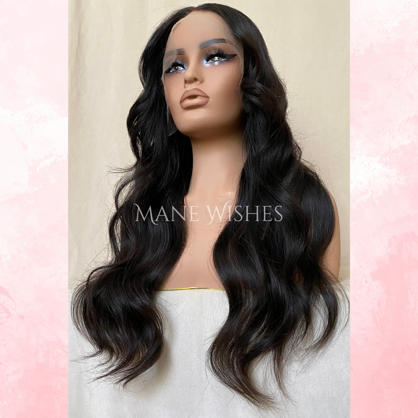 Mannequin head with long black wavy hair on a light pink background, branded 'Mane Wishes'.