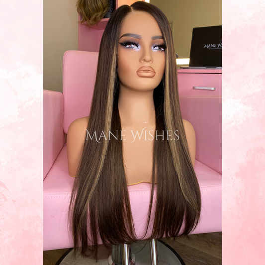 Mannequin head with a long brown wig on a pink chair, branded 'Mane Wishes'.