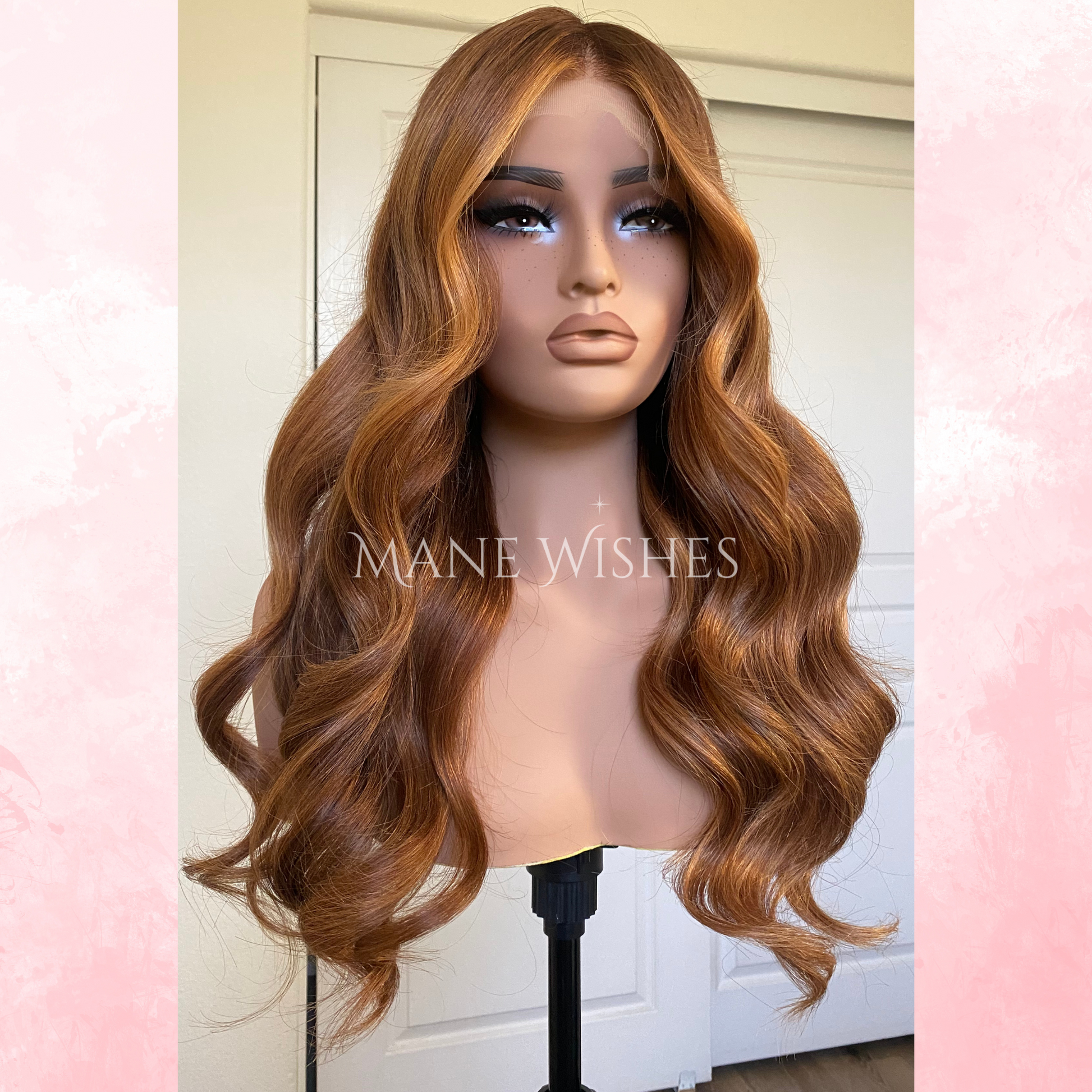 Mannequin head with long wavy brown wig on a stand, branded 'Mane Wishes'.